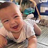 Noah is registered to the contest to win money with this photo: baby, smiling, indoor, mat, crawling, child, happy, toy, furniture, floor, person, cute, infant, playtime, home, bright, expression, toddler, clothing, skin