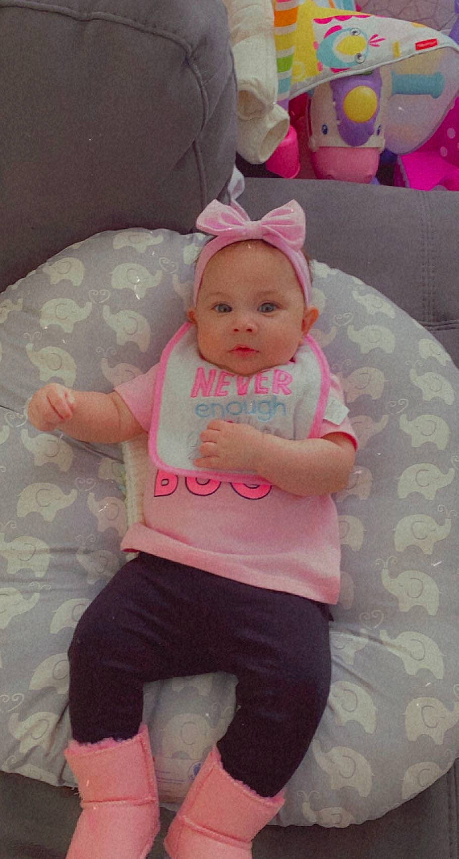 Ciara is registered to the contest to win money with this photo: arm, baby, baby_toddler_clothing, cheek, comfort, eye, finger, hand, happy, head, human_body, knee, leg, mouth, person, pink, skin, sleeve, textile, thigh