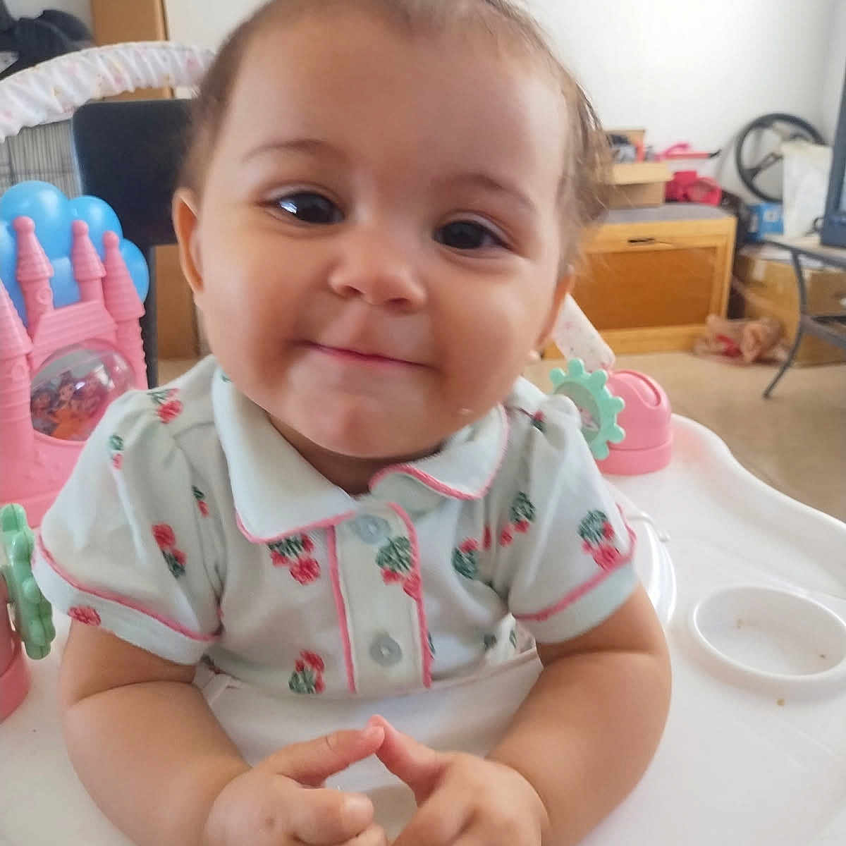 Sahfire joined the competition — help win amazing prizes! baby, child, close_up, clothing, collar, eyes, face, furniture, hair, hands, highchair, indoor, living_room, meal_time, pink_toy, ponytail, portrait, smiling, toy, wooden_drawer