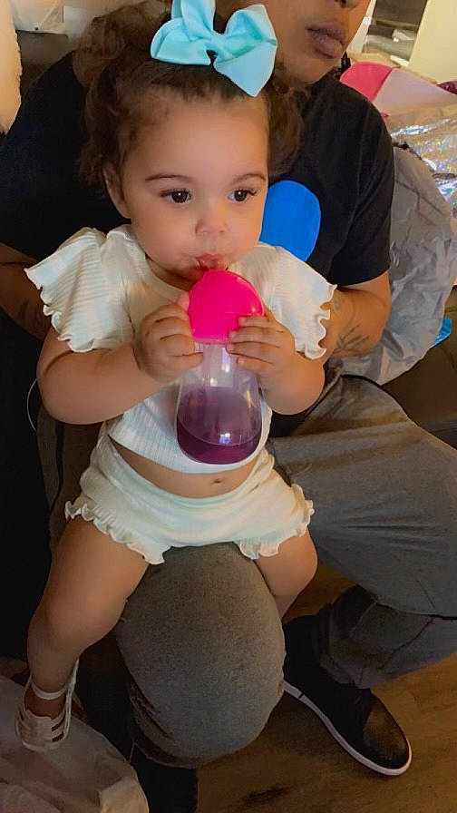 Julianne is registered to the contest to win money with this photo: abdomen, baby, chest, child, drinkware, event, finger, fun, gesture, happy, human_leg, joint, leg, person, pink, shorts, skin, thigh, thumb, toddler