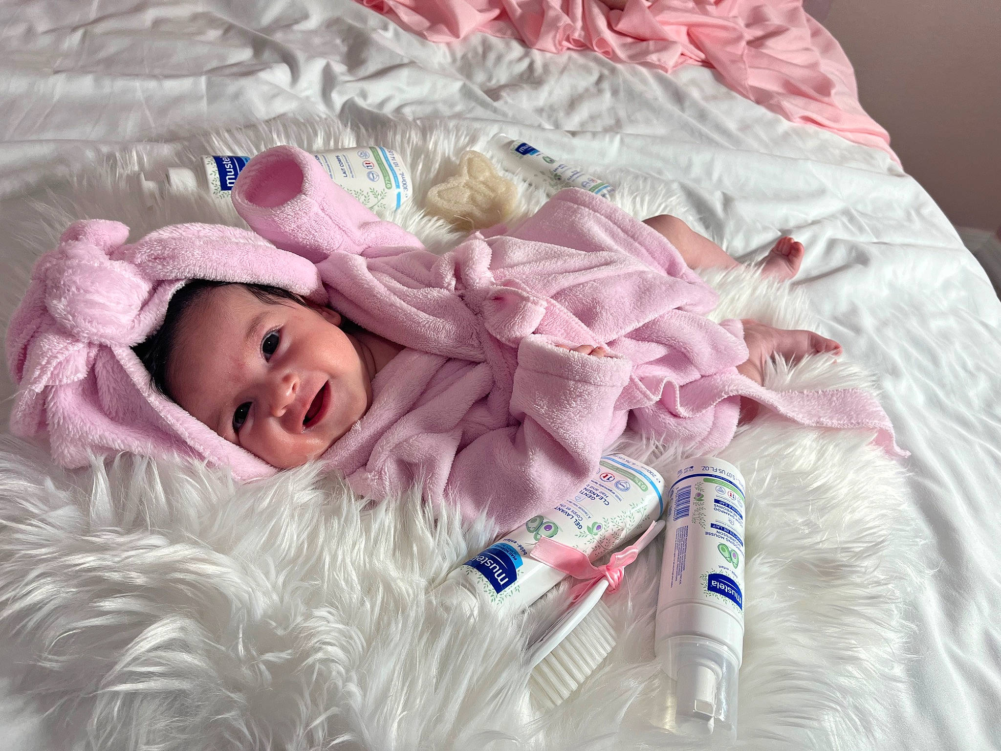 Monserrat joined the competition — help win amazing prizes! baby, baby_products, baby_toddler_clothing, beanie, cap, child, comfort, fashion_accessory, fur, happy, headgear, linens, magenta, pattern, person, pink, room, sleeve, smile, textile