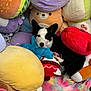 Winton joined the competition — help win amazing prizes! dog, black_and_white, plush_toys, pillows, stuffed_animals, cozy, colorful, cute, pet, indoor, resting, soft, cuddly, animal, toy, comfort, playful, relaxed, furry, companion