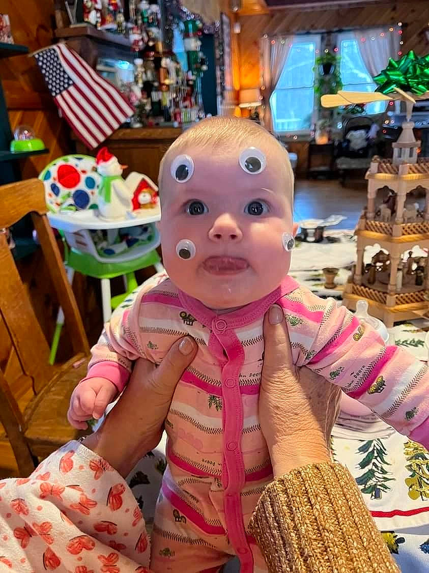 Mackenzie is registered to the contest to win money with this photo: chair, child, entertainment, event, fashion_accessory, flag, flesh, fun, fur, hat, holiday, leisure, pattern, performing_arts, person, room, stuffed_toy, tie, toddler, toy