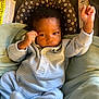 Uriah joined the competition — help win amazing prizes! baby, blanket, car_seat, child, cozy, curious, cushion, cute, face, fist, hand, indoor, infant, onesie, portrait, raised_arm, resting, sleepwear, soft_lighting, striped_clothing