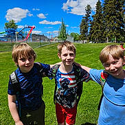 Dean joined the competition — help win amazing prizes! child, boys, backpacks, outdoor, park, grass, trees, playground, waterslides, fence, sky, clouds, sunny, casual_clothing, friends, smiling, group, summer, recreation, fun