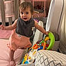 toddler, child, baby, toy, play, indoor, crib, mat, pink, clothing, bib, furniture, air_purifier, room, balance, curious, person, young_child, home, soft