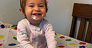 Araceli joined the competition — help win amazing prizes! birthday, cake, celebration, child, clothing, cream, face, frosting, fun, hands, happy, indoor, messy, party, pink_crown, sitting, smile, tablecloth, toddler, wooden_chair