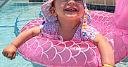 Araceli is registered to the contest to win money with this photo: baby, child, daylight, floating, fun, happy, hat, inflatable_ring, outdoor, pink, playful, pool, smiling, summer, sun_hat, sunshine, swimming_pool, toddler, vacation, water