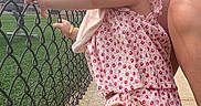 Araceli is registered to the contest to win money with this photo: toddler, child, pink_sandals, floral_outfit, chain_link_fence, sidewalk, outdoor, daylight, person, footwear, grass, sky, hair_bow, bracelet, smile, holding, confident, cute, summer, casual