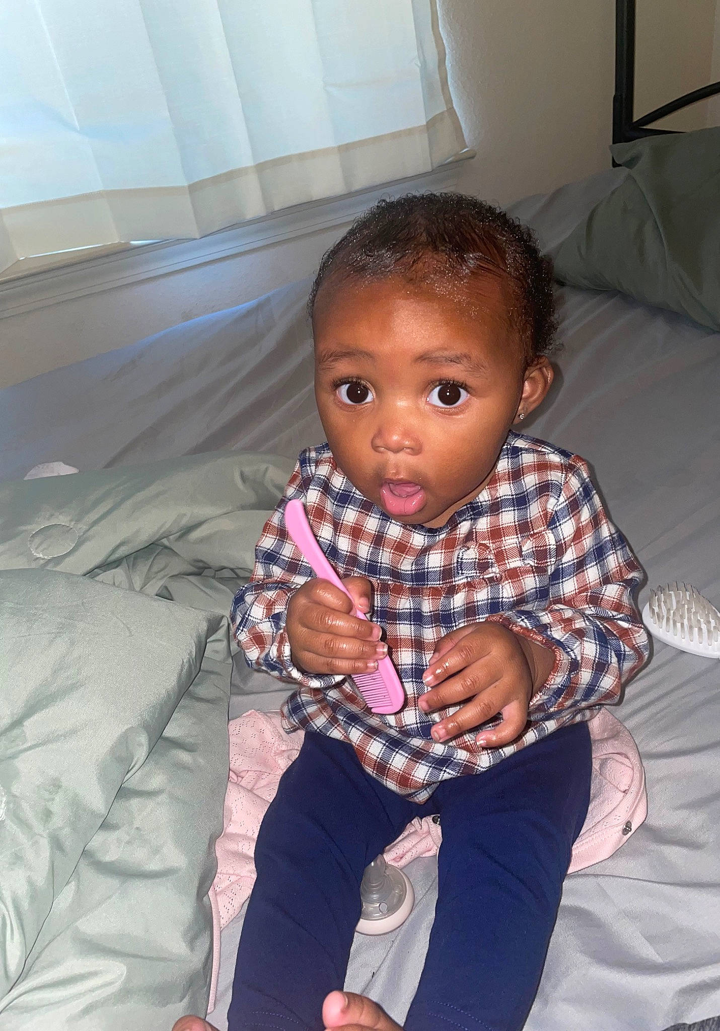 Leilani is registered to the contest to win money with this photo: baby, baby_toddler_clothing, cheek, child, comfort, floor, flooring, fun, happy, linens, pattern, person, plaid, portrait_photography, room, sitting, skin, sleeve, sock, surprise