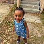 toddler, child, outdoor, grass, leaves, steps, porch, brick_wall, concrete, romper, polka_dot, smiling, hair_buns, sneakers, white_socks, happy, person, young_child, casual_clothing, daylight