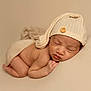 baby, beige, blanket, button, child, closeup, cozy, curled_up, cute, hat, infant, knit_hat, newborn, peaceful, portrait, resting, skin, sleeping, soft, warm_tones