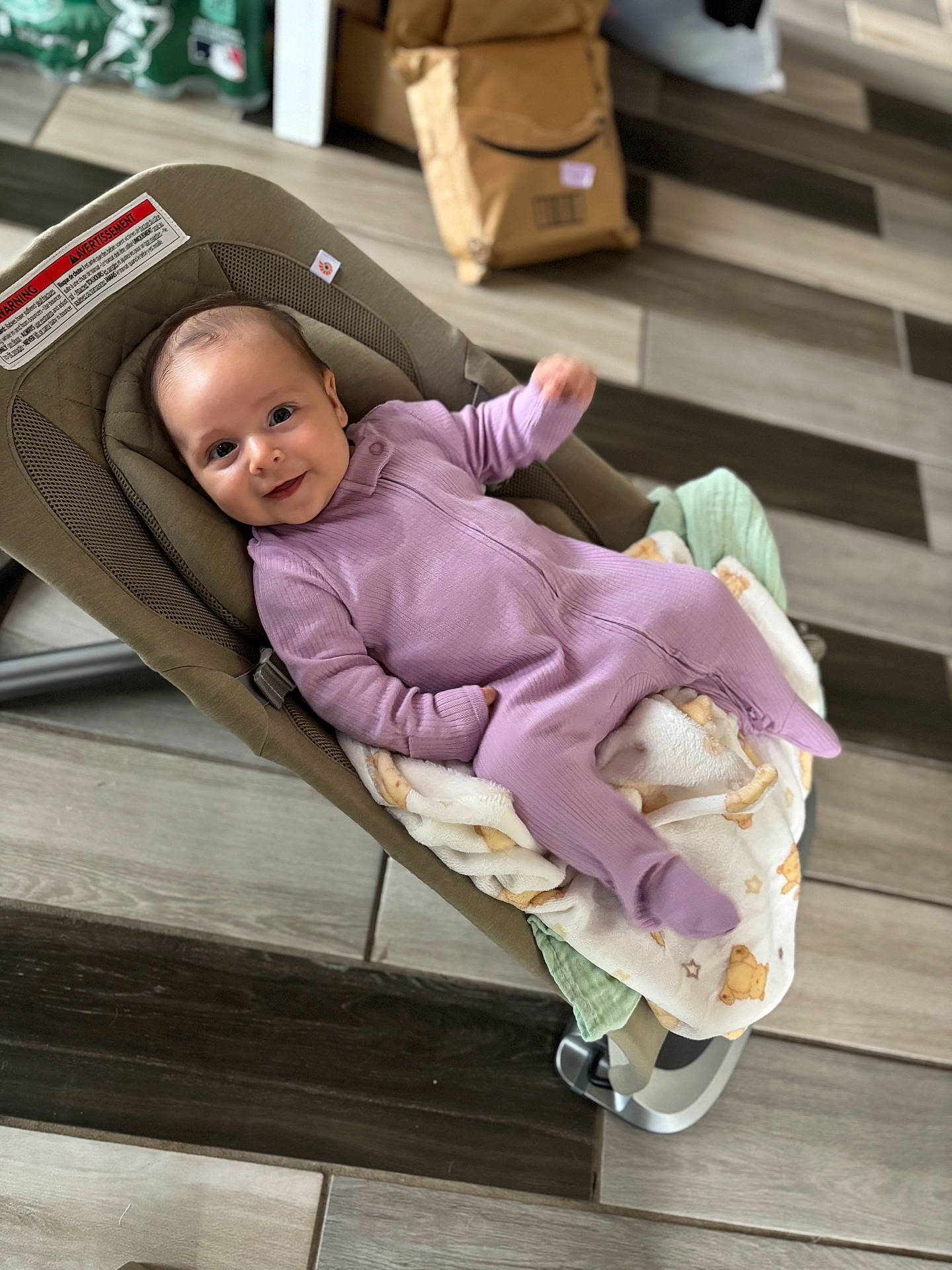 Isabella joined the competition — help win amazing prizes! baby, baby_rocker, blanket, child, clothing, cozy, cushion, cute, face, floor_tiles, happy, home, indoor, infant, onesie, package, person, portrait, smiling, toddler