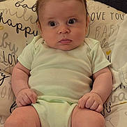 Mason joined the competition — help win amazing prizes! baby, infant, child, portrait, sitting, indoors, cushion, pillow, onesie, green_clothing, wide_eyes, facial_expression, spiky_hair, light_skin, arms, legs, hands, baby_furniture, home, photography