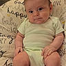 baby, infant, child, portrait, sitting, cushion, blanket, onesie, clothing, face, hair, eyes, hands, legs, feet, indoors, home, furniture, serious_expression, photography