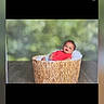 Amanuel is registered to the contest to win money with this photo: baby, basket, red_clothing, smiling, indoor, portrait, infant, cute, cushion, woven_basket, child, happy, sitting, head, face, background_blur, floor, photography, social_media, username