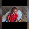baby, smiling, red_shirt, basket, fluffy, wooden_floor, child, cute, happy, indoors, portrait, seated, infant, cozy, young_child, skin, hair, person, casual_clothing, comfortable
