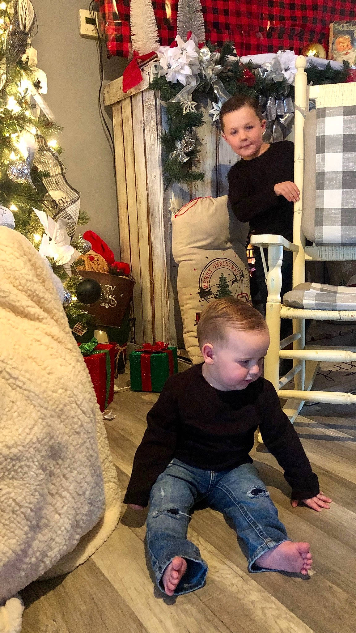 Aiden is registered to the contest to win money with this photo: child, christmas_decoration, christmas_ornament, christmas_tree, event, flooring, fun, happy, holiday, ornament, people, person, photograph, red, smile, snapshot, standing, toddler, tree, white
