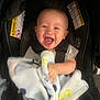 baby, smiling, blanket, car_seat, child, happy, infant, clothing, seatbelt, cute, portrait, person, sitting, indoors, toddler, head, face, baby_blanket, seat, comfort