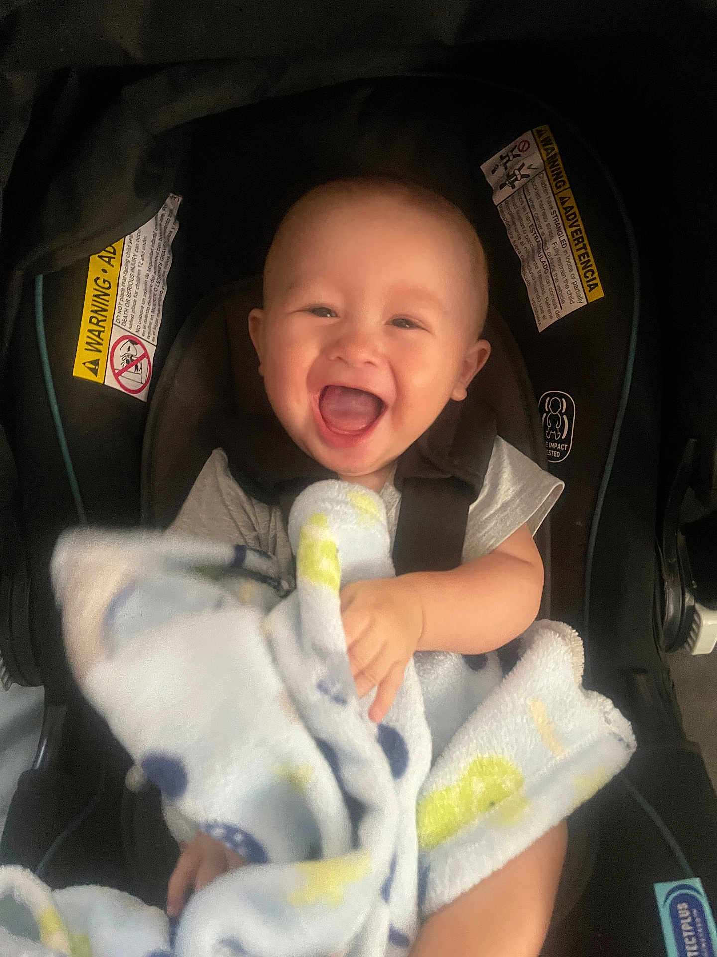 Giovanni joined the competition — help win amazing prizes! baby, smiling, blanket, car_seat, child, happy, infant, clothing, seatbelt, cute, portrait, person, sitting, indoors, toddler, head, face, baby_blanket, seat, comfort