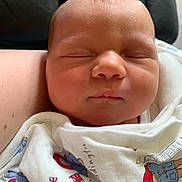 Esme is registered to the contest to win money with this photo: newborn, baby, sleeping, face, blanket, infant, closeup, peaceful, child, soft, skin, portrait, resting, cute, clothing, indoors, human, person, lying_down, comfort