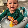 Anthony joined the competition — help win amazing prizes! baby, child, walker, toy, mickey_mouse, smile, face, hand, clothing, floor, wood_floor, furniture, sleeve, green_shirt, indoor, person, happy, seat, playtime, infant