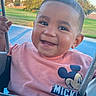 Anthony is registered to the contest to win money with this photo: toddler, child, smiling, swing, playground, outdoor, park, tree, grass, blue_sky, mickey_mouse, shirt, happy, face, person, daylight, cute, summer, fun, baby