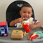 Anthony joined the competition — help win amazing prizes! toddler, baby, high_chair, food, fries, mcdonalds, happy_meal, chicken_mcnuggets, apple_slices, bib, smiling, cute, bracelet, indoor, meal, child, sitting, table, fast_food, snack