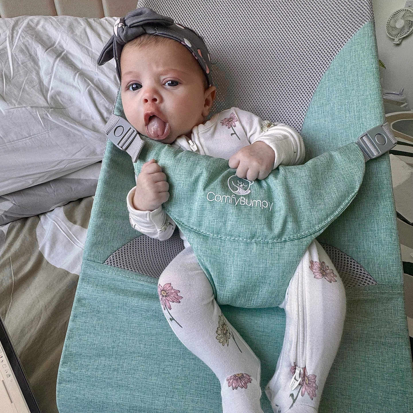 Amber Nicole joined the competition — help win amazing prizes! baby, baby_seat, bed, blanket, child, comfort, comfybumppy, cute, expression, floral_pattern, furniture, green, hand_grip, headband, indoor, infant, laptop, onesie, sitting, tongue_out