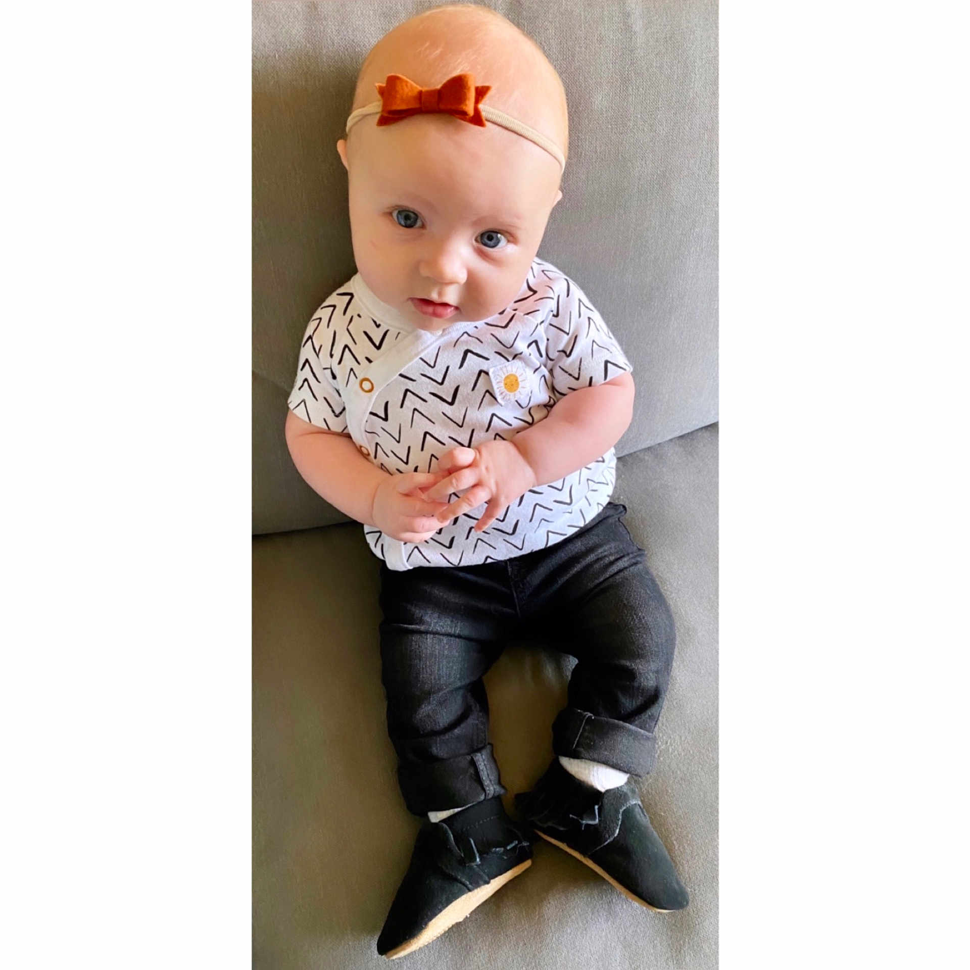 Marlowe is registered to the contest to win money with this photo: baby, beige, child, design, footwear, head, headgear, jeans, pattern, product, shoe, sitting, sleeve, t_shirt, toddler, trousers
