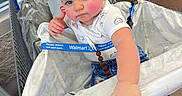Freya joined the competition — help win amazing prizes! baby, child, shopping_cart, indoor, clothing, jeans, shirt, hand, face, blue_eyes, floor, store, retail, curious, rosy_cheeks, expression, person, footwear, shopping, seat_cover
