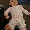 Freya joined the competition — help win amazing prizes! baby, barefoot, blanket, blue_eyes, carpet, casual_photo, child, face, floor, foot, home, indoors, infant, lying_down, pajamas, pink, portrait, sitting, sock, striped_clothing