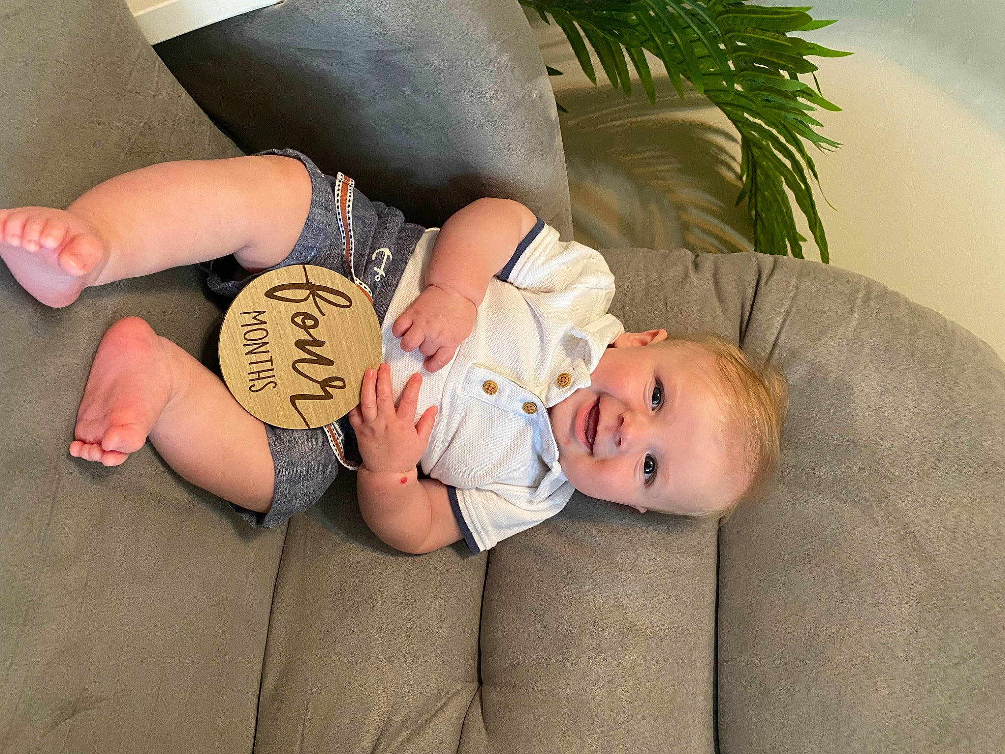 Briar is registered to the contest to win money with this photo: baby, baby_toddler_clothing, child, comfort, elbow, foot, gesture, happy, hat, houseplant, human_leg, joy, knee, lap, person, plant, sitting, skin, smile, thigh