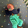 baby, sleeping, pacifier, crib, space_theme, planets, stars, rockets, clothing, suspenders, pants, slippers, blanket, infant, cute, indoors, child, resting, cute_outfit, nursery