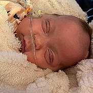 Jazmine joined the competition — help win amazing prizes! baby, sleeping, blanket, face, nasal_cannula, infant, closeup, soft_texture, cozy, healthcare, child, person, resting, wrapped, cute, newborn, skin, peaceful, indoors, comfort