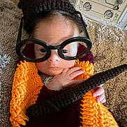 Larry joined the competition — help win amazing prizes! baby, blanket, brown, candid, carpet, child, closeup, cozy, curious, cute, face, glasses, hand, indoor, infant, knitted_outfit, orange, portrait, vintage_stove, warm