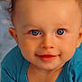 Leeroy participe au concours pour gagner de l'argent avec cette photo : baby, child, blue_eyes, curly_hair, smiling, portrait, close_up, infant, cute, happy, young_child, skin, face, clothing, sitting, expression, blue_shirt, hands, looking_at_camera, indoors