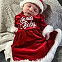 baby, sleeping, red_dress, santa_hat, holiday, christmas, festive, soft_blanket, infant, cute, white_trim, cozy, portrait, indoor, child, celebration, holiday_outfit, smiling_face, adorable, peaceful