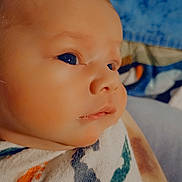 Ash is registered to the contest to win money with this photo: baby, infant, closeup, face, blanket, swaddle, footprints, colorful, soft, peaceful, curious, gaze, child, newborn, portrait, skin, head, eyes, indoors, cozy