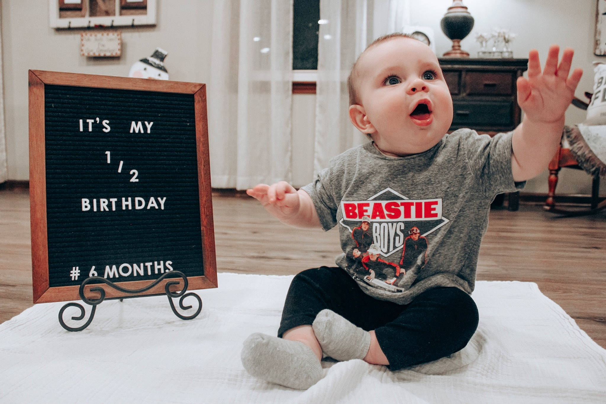 Caden joined the competition — help win amazing prizes! baby, baby_grabbing_for_something, baby_products, baby_toddler_clothing, child, finger, flooring, foot, hand, hardwood, human, long_sleeved_t_shirt, person, photo_caption, picture_frame, product, sitting, sock, surprise, toddler