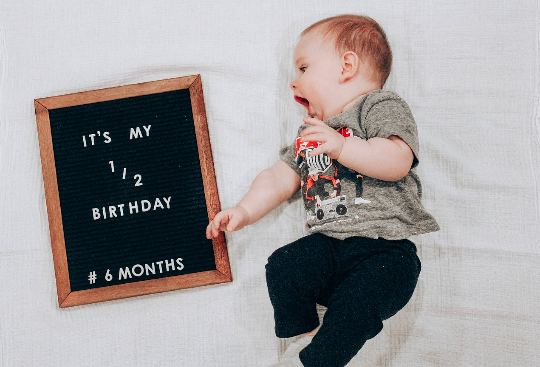 Caden is registered to the contest to win money with this photo: baby, baby_toddler_clothing, blackboard, cheek, child, child_model, comfort, denim, person, photo_shoot, portrait_photography, product, sleeve, toddler