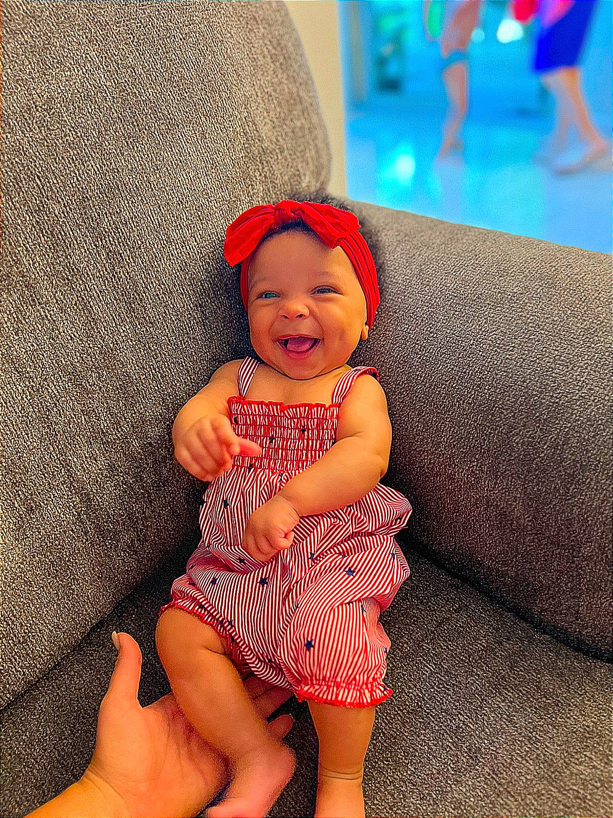 Wrenley is registered to the contest to win money with this photo: baby, baby_toddler_clothing, cap, comfort, costume_hat, couch, day_dress, eye, fun, happy, hat, human_body, human_leg, one_piece_garment, pattern, person, skin, smile, sun_hat, thigh