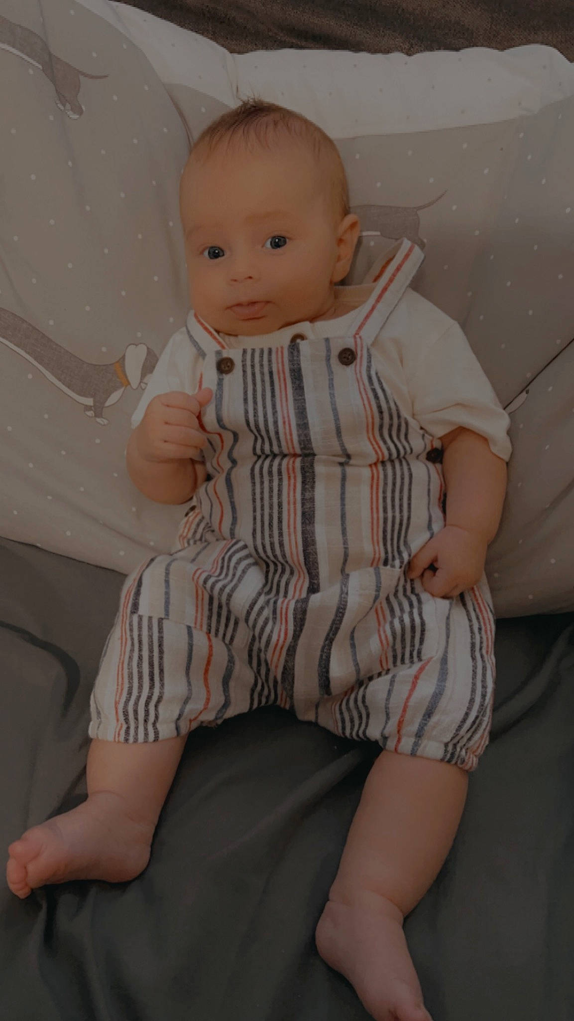 Archie is registered to the contest to win money with this photo: arm, baby, baby_toddler_clothing, cheek, child, comfort, finger, human_leg, joint, knee, pattern, person, shoulder, sitting, skin, sleeve, sock, standing, textile, thigh