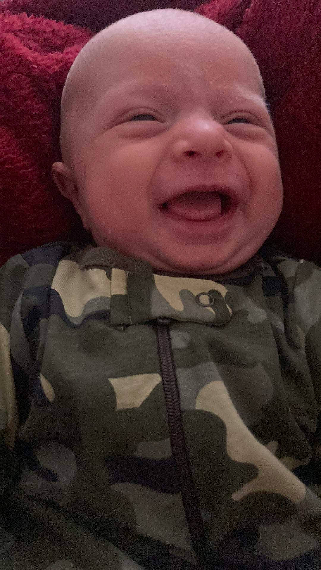 Oaklei is registered to the contest to win money with this photo: baby, baby_laughing, baby_toddler_clothing, camouflage, cheek, child, chin, comfort, face, gesture, happy, human_body, iris, military_camouflage, mouth, nose, person, skin, sleeve, smile