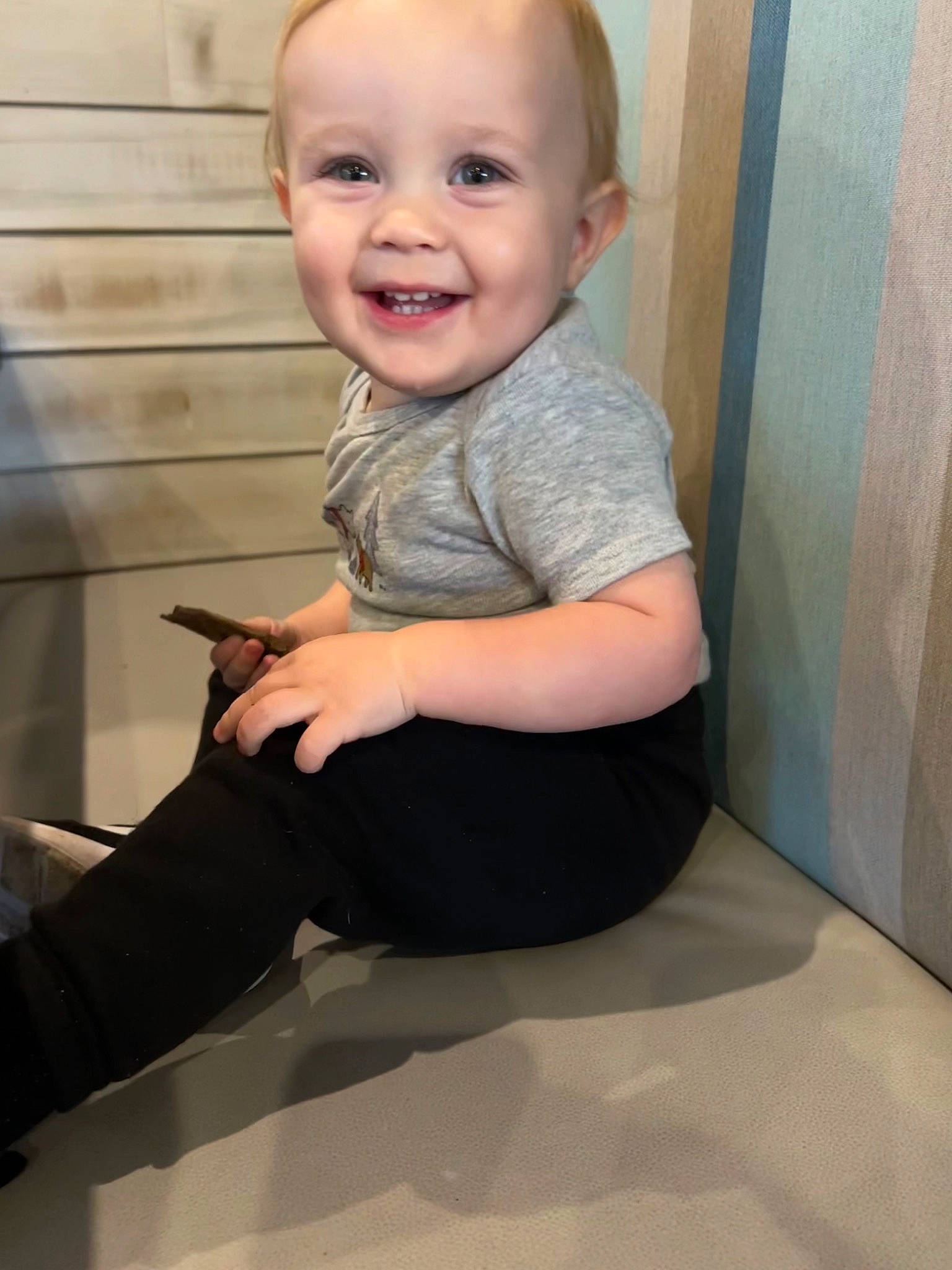 Eli is registered to the contest to win money with this photo: baby, baby_toddler_clothing, cheek, comfort, eye, finger, flooring, gesture, head, human_body, joint, joy, knee, leg, person, skin, sleeve, smile, standing, thigh