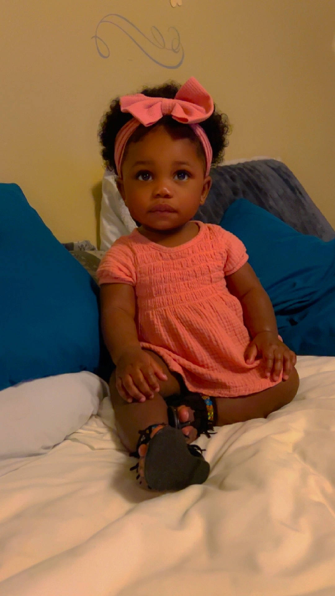 Kenzley is registered to the contest to win money with this photo: accessories, baby, bed, bedroom, bodypart, clothing, couch, cushion, face, finger, furniture, hand, hat, head, homedecor, linen, person, photography, portrait, sitting