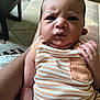 Elsadig is registered to the contest to win money with this photo: baby, infant, child, person, striped_clothing, orange, white, hand, arm, indoor, carpet, furniture, closeup, portrait, skin, expression, newborn, cute, holding, young