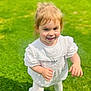 baby, child, cute, daylight, face, feet, grass, greenery, happy, nature, outdoor, person, playful, portrait, smiling, sunlight, toddler, walking, white_dress, young_child