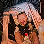 Kai is registered to the contest to win money with this photo: baby, smiling, car_seat, infant, socks, straps, pacifier, blanket, clothing, happy, face, head_support, indoor, seat, child, cute, person, comfort, baby_toys, portrait