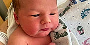 Luka is registered to the contest to win money with this photo: newborn, baby, infant, hospital, blanket, footprints, id_bracelet, skin, face, hand, arm, person, newborn_baby, hospital_room, closeup, fresh, cute, child, wrapped, soft_light